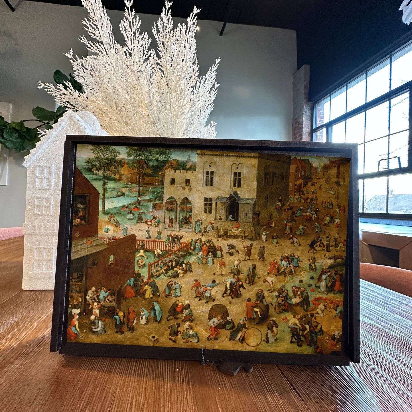 Bruegel’s ‘Children’s Games’ wooden jigsaw puzzle featuring a bustling 16th-century Flemish town square filled with traditional childhood games.