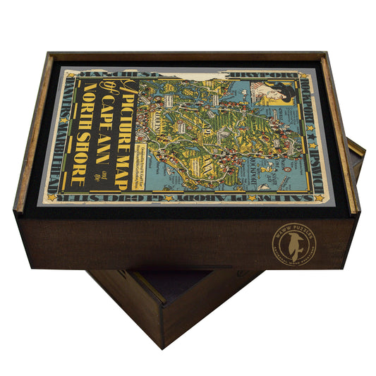 Collectible wooden puzzle of a vintage pictorial map of Cape Ann and the North Shore in Massachusetts, featuring illustrations of towns, landmarks, and coastal scenery. Retro style art print for travel and home decor.