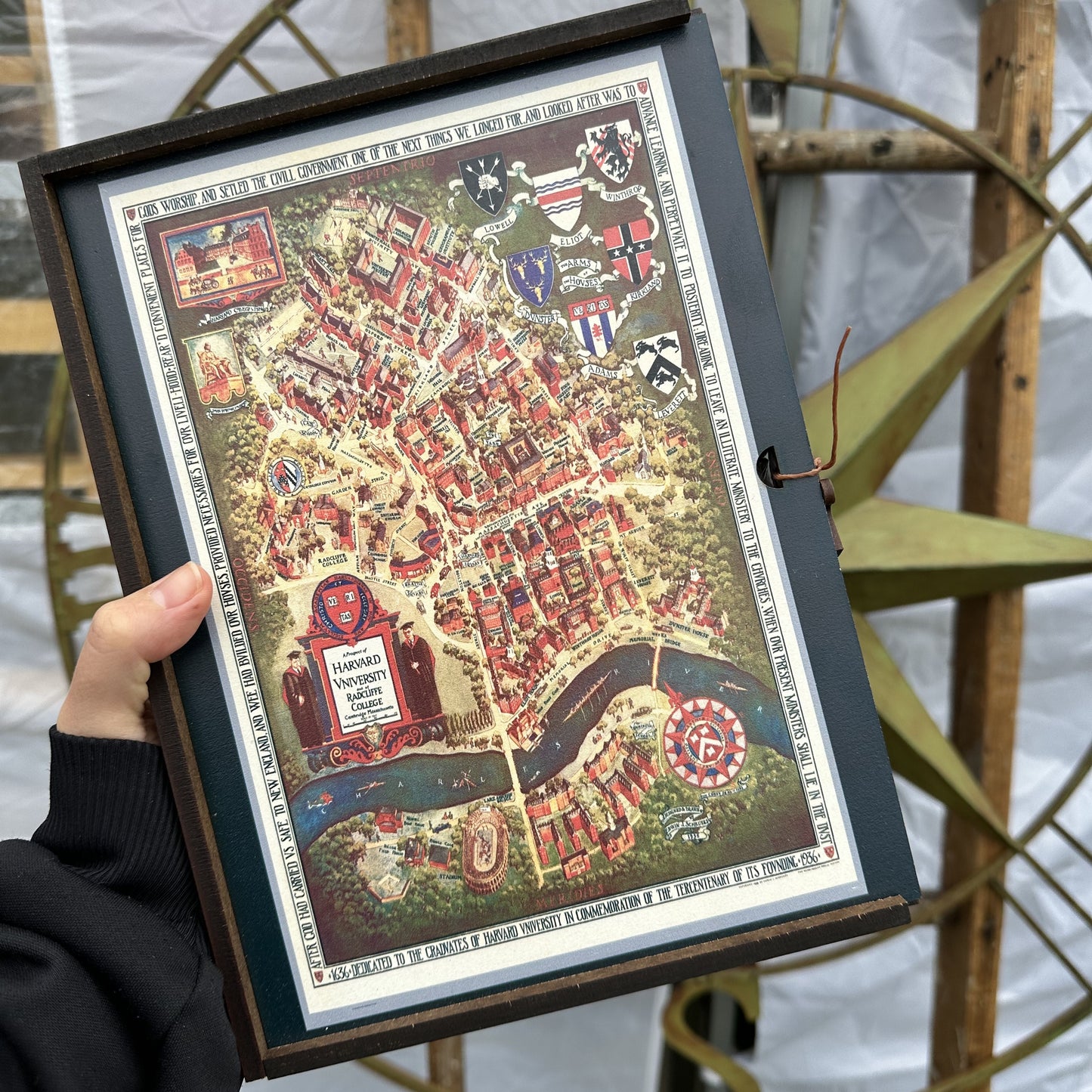 A high-quality wooden jigsaw puzzle of a vintage pictorial map of Harvard University and Radcliffe College, featuring historic buildings, crests, and decorative elements. Comes in a handmade wooden keepsake box.