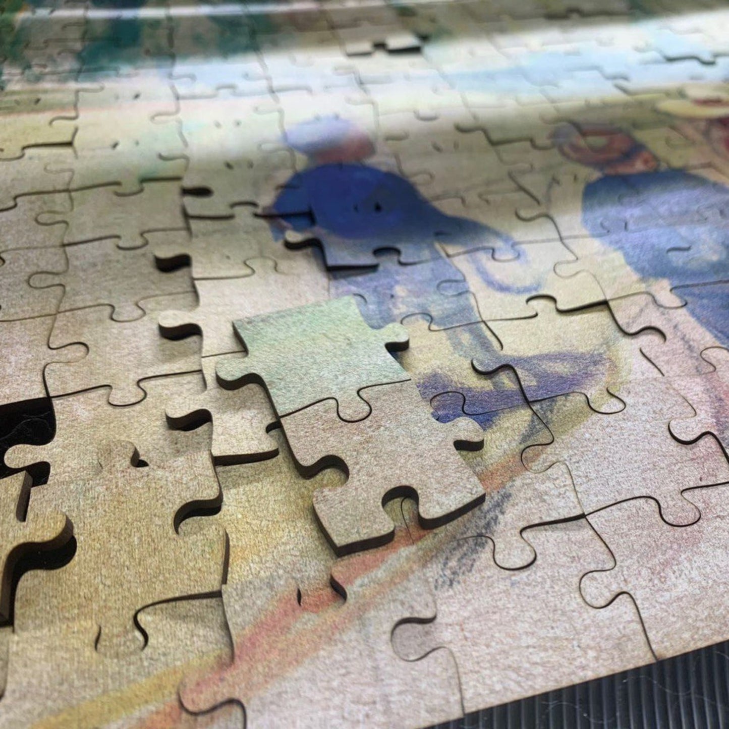 The image is a close-up of a jigsaw puzzle with several pieces missing, revealing the partially completed puzzle.