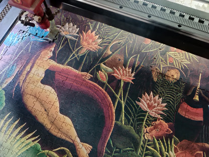 Henri Rousseau’s ‘The Dream’ wooden jigsaw puzzle, featuring a lush jungle scene with exotic animals, vibrant foliage, and a reclining nude figure.