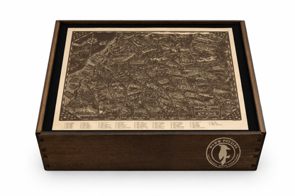 Artisan wooden puzzle box featuring Landacre's satirical star map. Wooden puzzle box with a map design on the lid and a brand logo on the side.