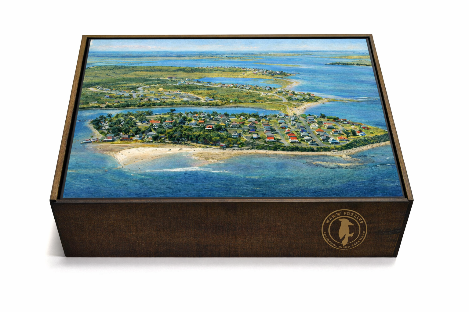 WAWW wooden puzzle in engraved keepsake box showing aerial watercolor view of New England coastal town with cottages, beach, and winding waterways.