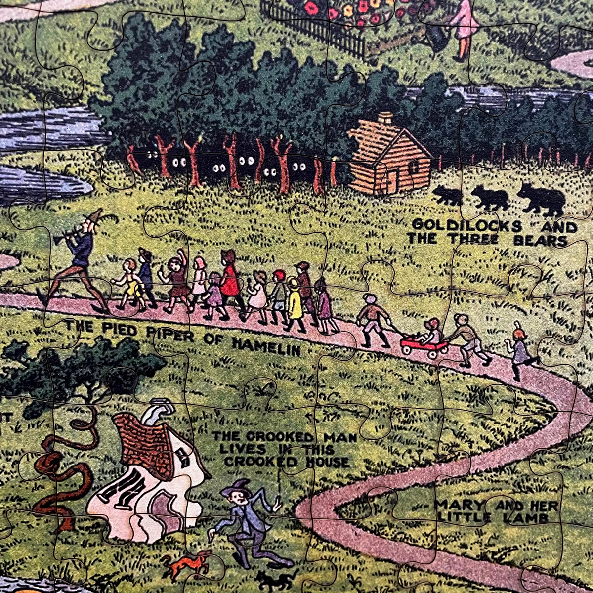 Close-up of partially completed The Land of Make Believe puzzle, with laser-cut wooden pieces mid-assembly.