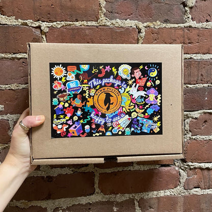 cardboard box containing a wooden jigsaw puzzle by waww artisanal 