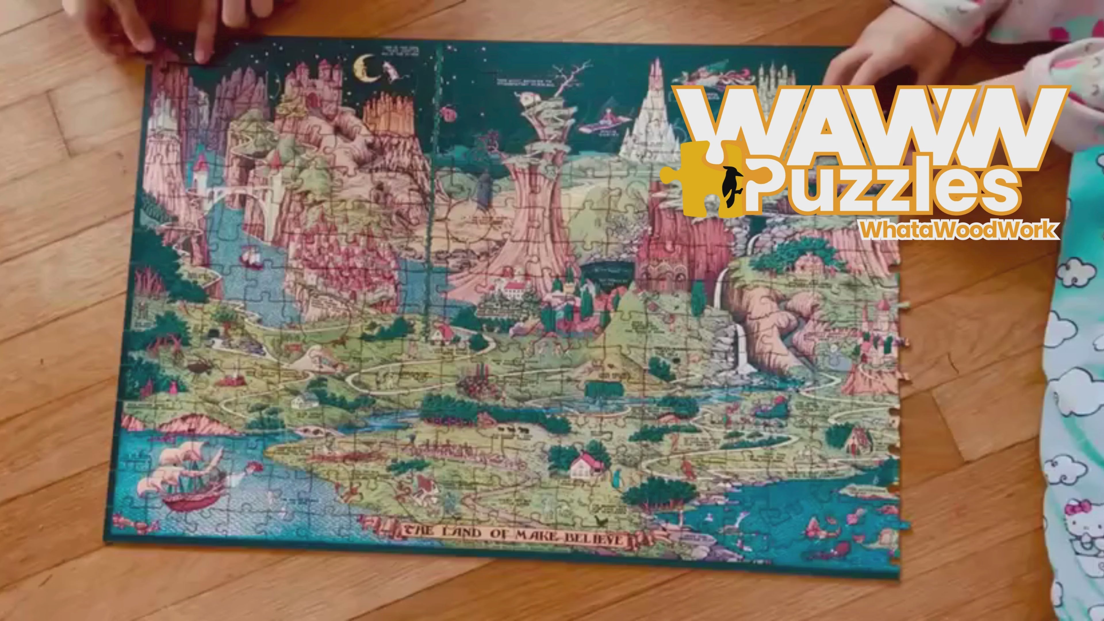 Load video: Children assembling The Land of Make Believe wooden puzzle on the floor