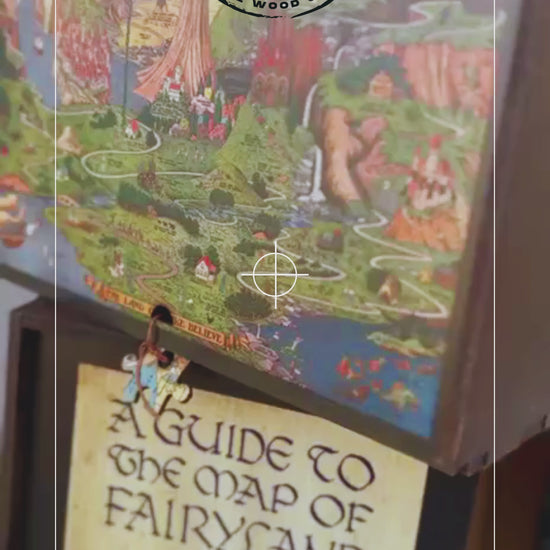 Flat lay of The Land of Make Believe wooden puzzle completed, showing vibrant fairytale map artwork by Jaro Hess.