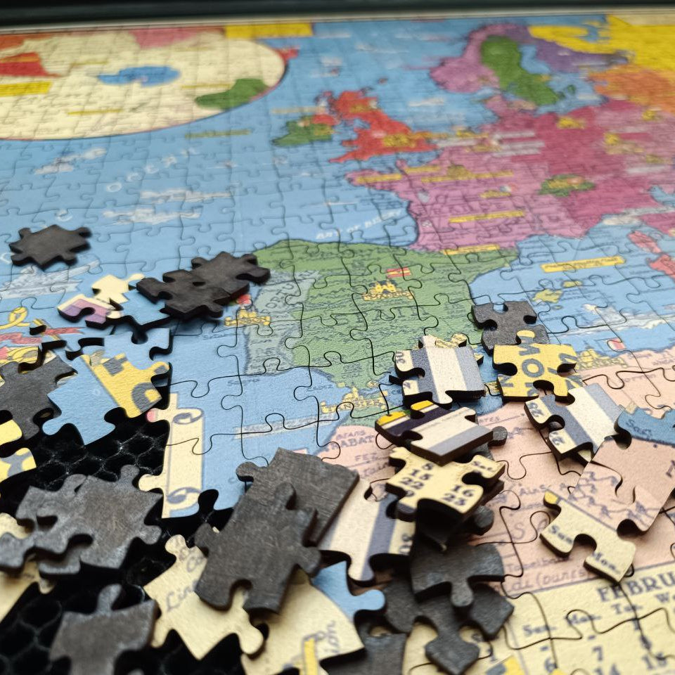 World map puzzle with pieces scattered on a partially completed puzzle
