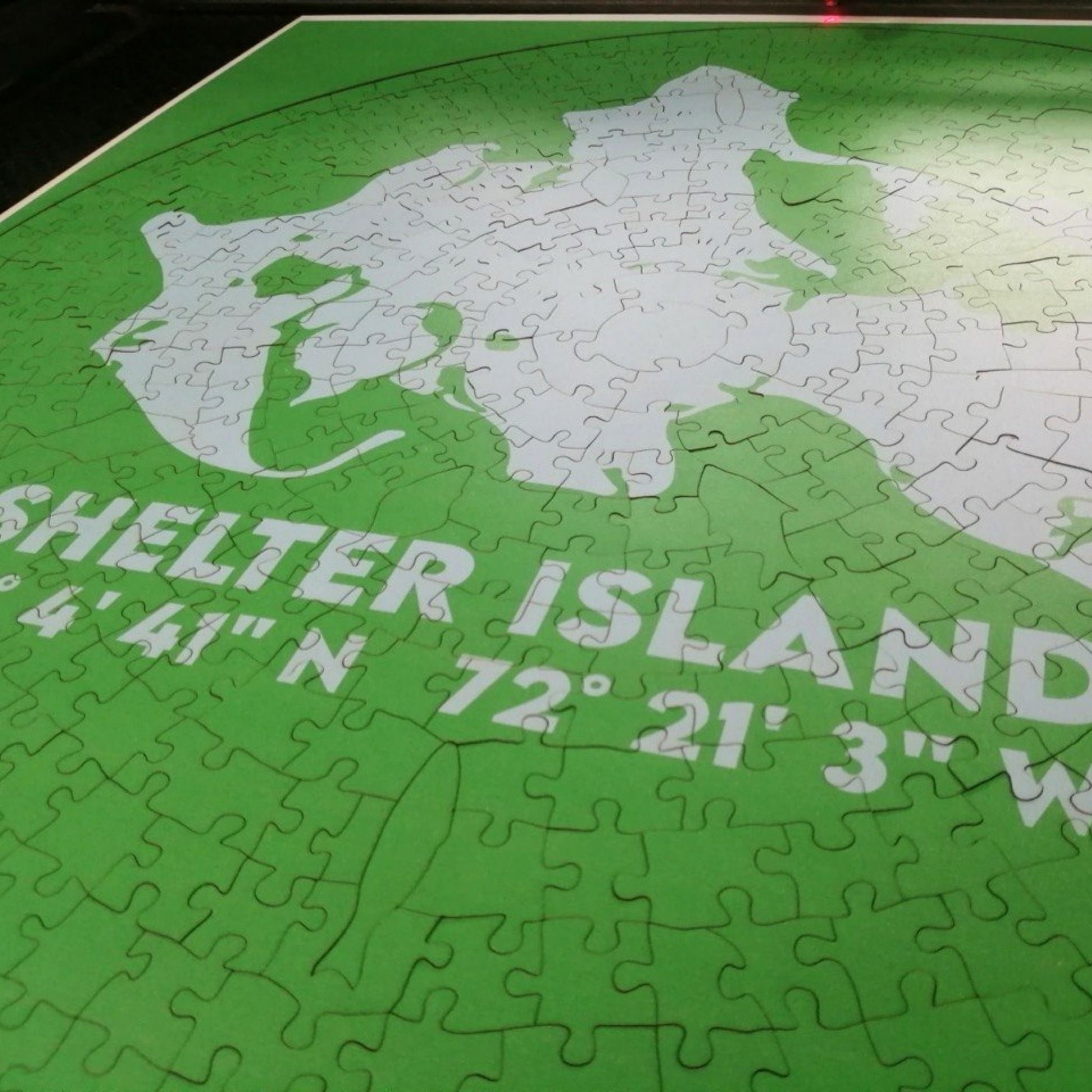 Jigsaw puzzle of Shelter Island with latitude and longitude coordinates on a green background