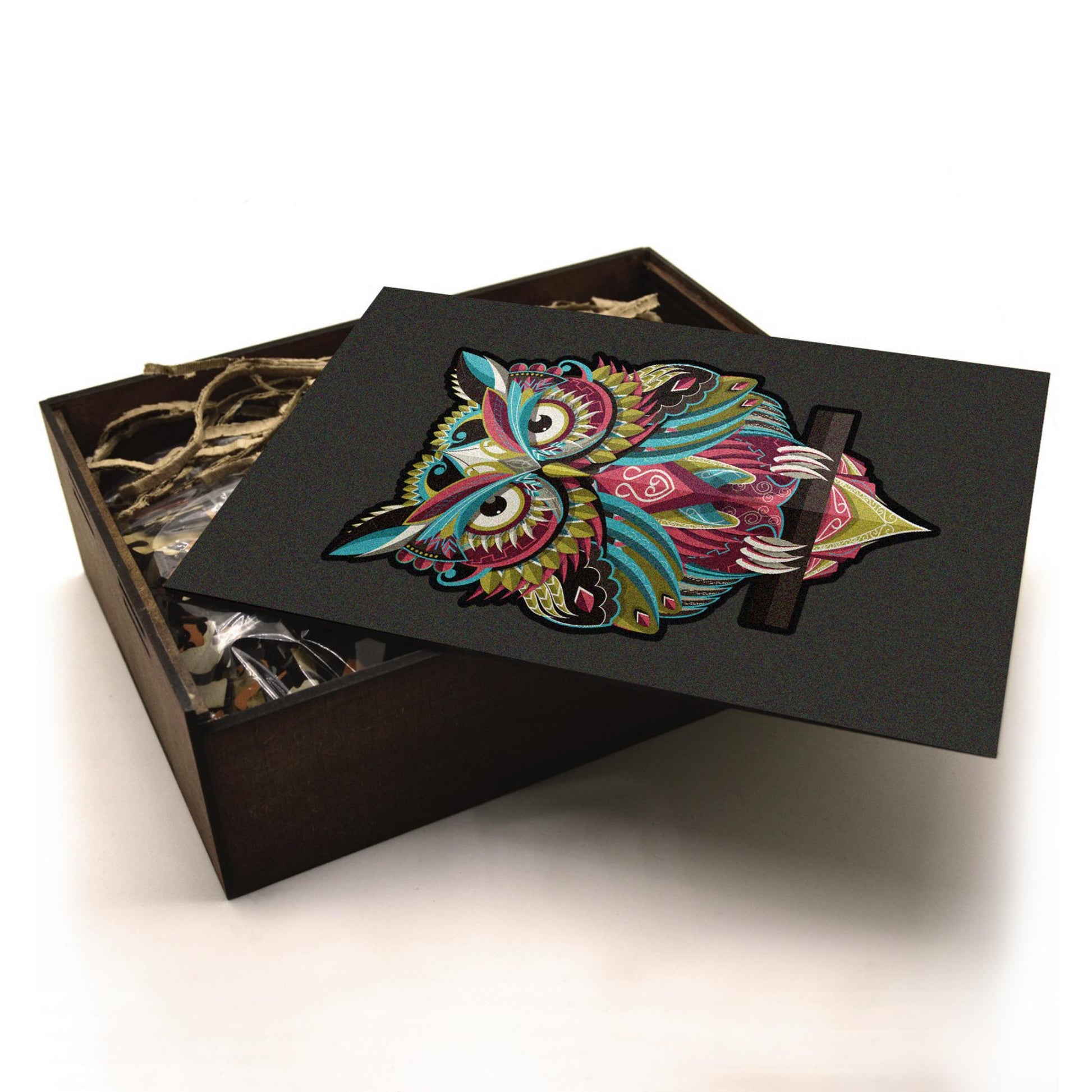 Handcrafted wooden box containing a colorful owl puzzle with intricate patterns. Unique and artistic gift.