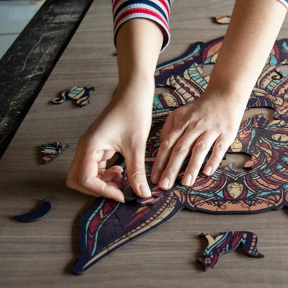 hands holding jigsaw pieces of a Colorful Wolf Wooden Jigsaw Puzzle: Stylized wolf with a vibrant, patterned body. Intricate wooden puzzle

