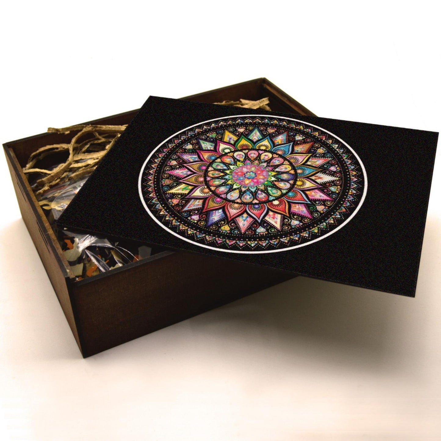 Handcrafted wooden box containing a colorful mandala puzzle with intricate patterns. Unique and artistic gift.