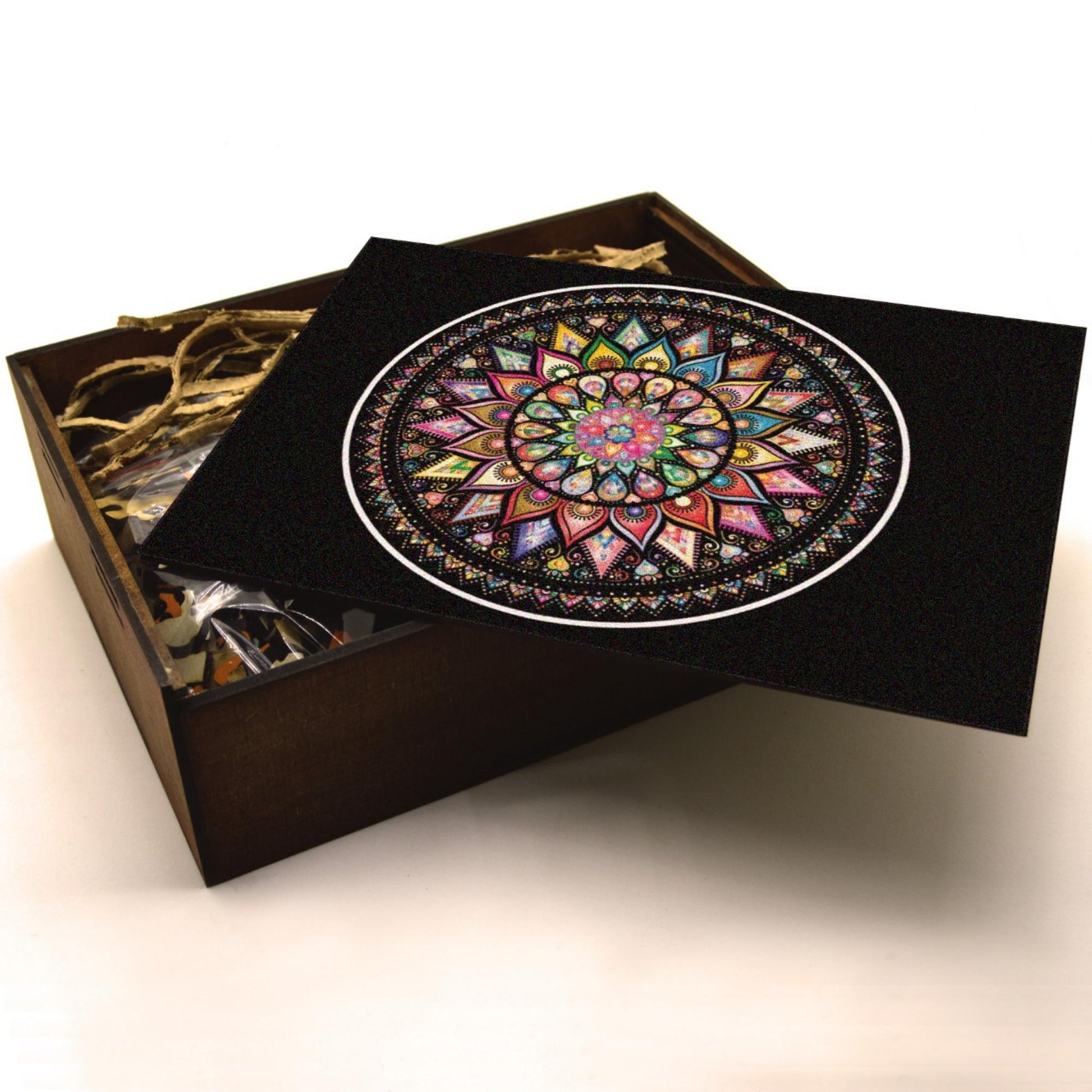 Handcrafted wooden box containing a colorful mandala puzzle with intricate patterns. Unique and artistic gift.