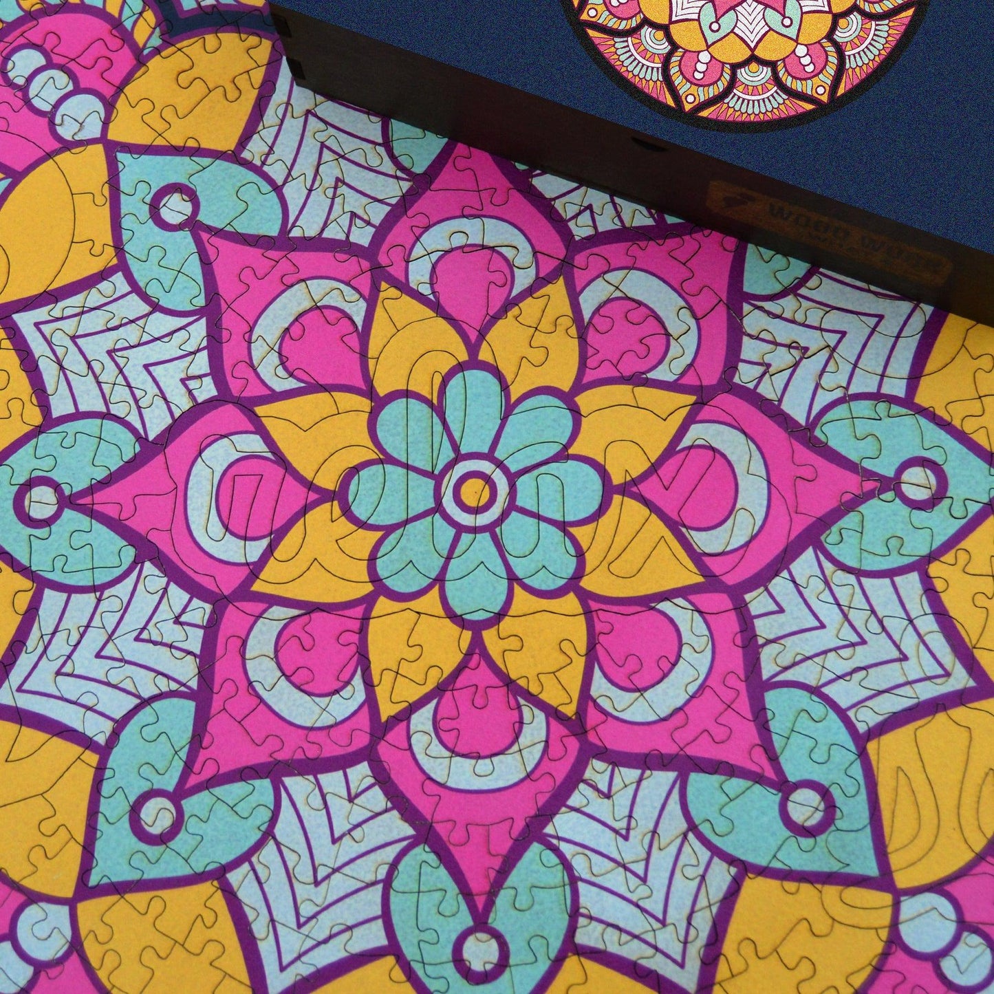 Handcrafted wooden box containing a colorful mandala puzzle with intricate patterns. Unique and artistic gift. WAWW Puzzles
